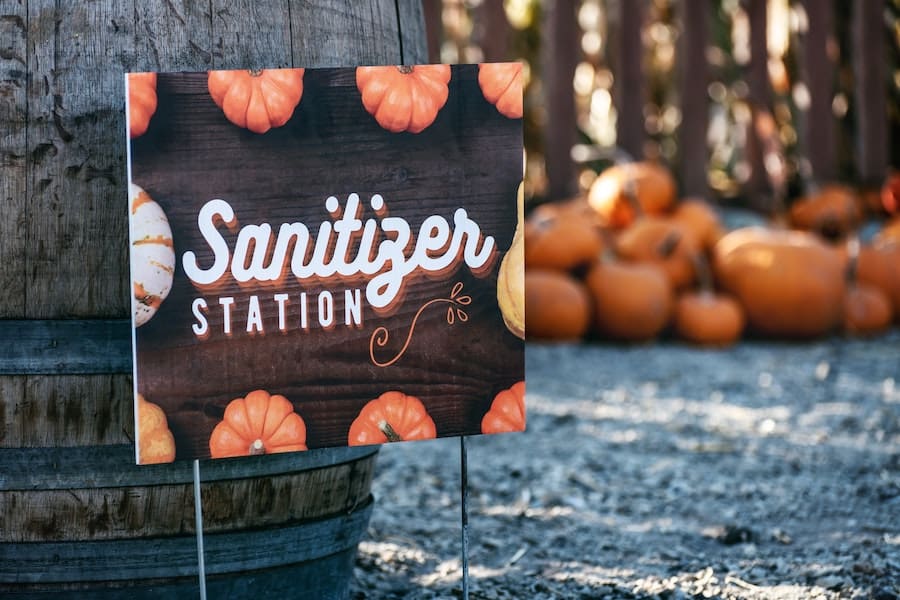 halloween during covid-19 - sanitizer station sign at pumpkin patch